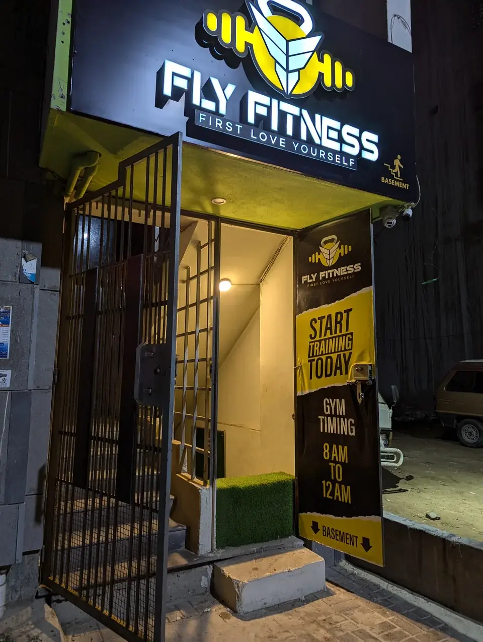 Fly Fitness sign above the building entrance